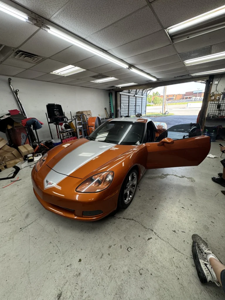 Orange Corvette inside the Mega Sound installation bay.