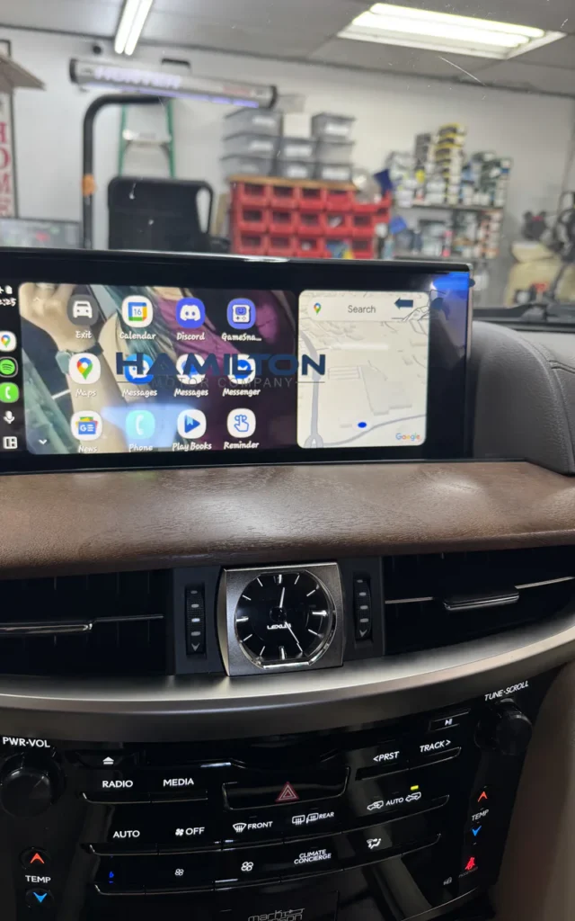Aftermarket multimedia display installed in a vehicle dashboard.
