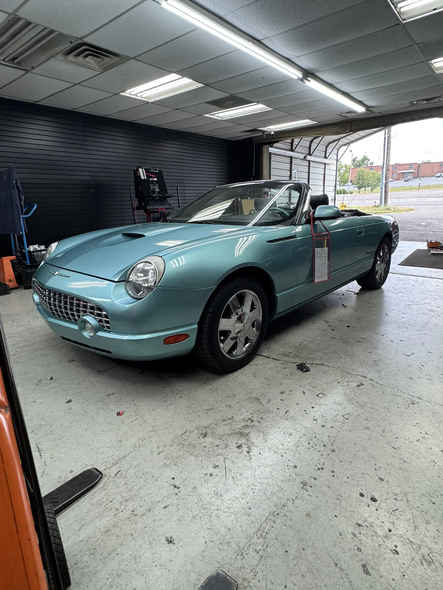 Teal Corvette inside the Mega Sound installation bay.