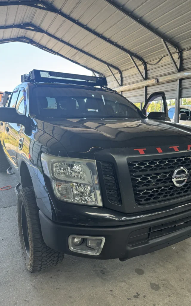 Ford F-150 shown with aftermarket black wheels.