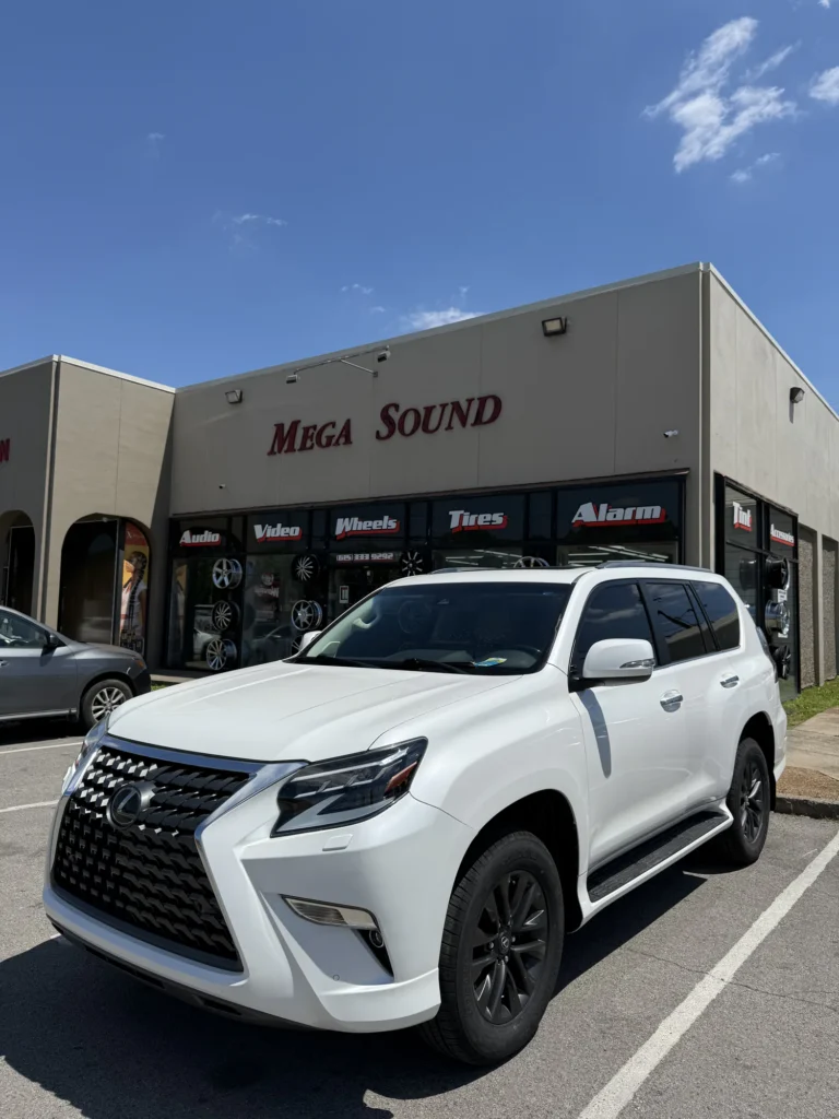 White Lexus SUV parked outside the Mega Sound shop.